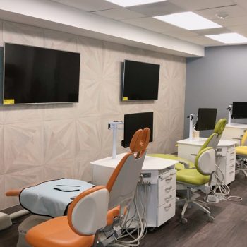 patient treatment room with multiple dental chairs