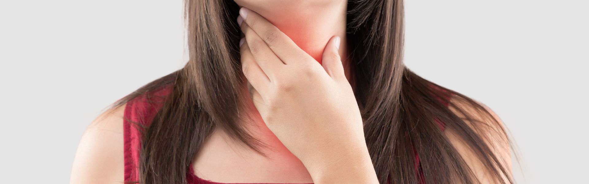 ore throat after tooth extraction – woman holding jaw in discomfort