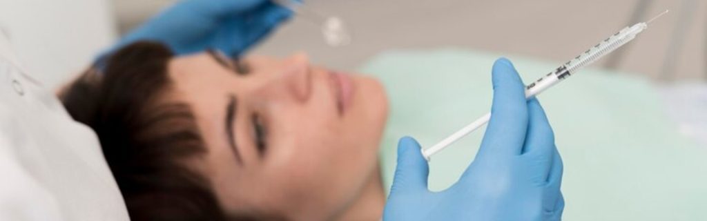Dentist giving lidocaine injection to a tooth
