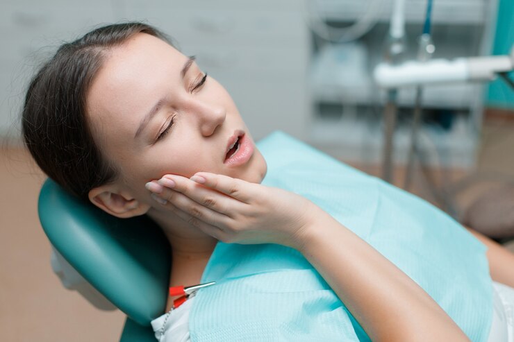 Female patient receiving lidocaine injection from dentist